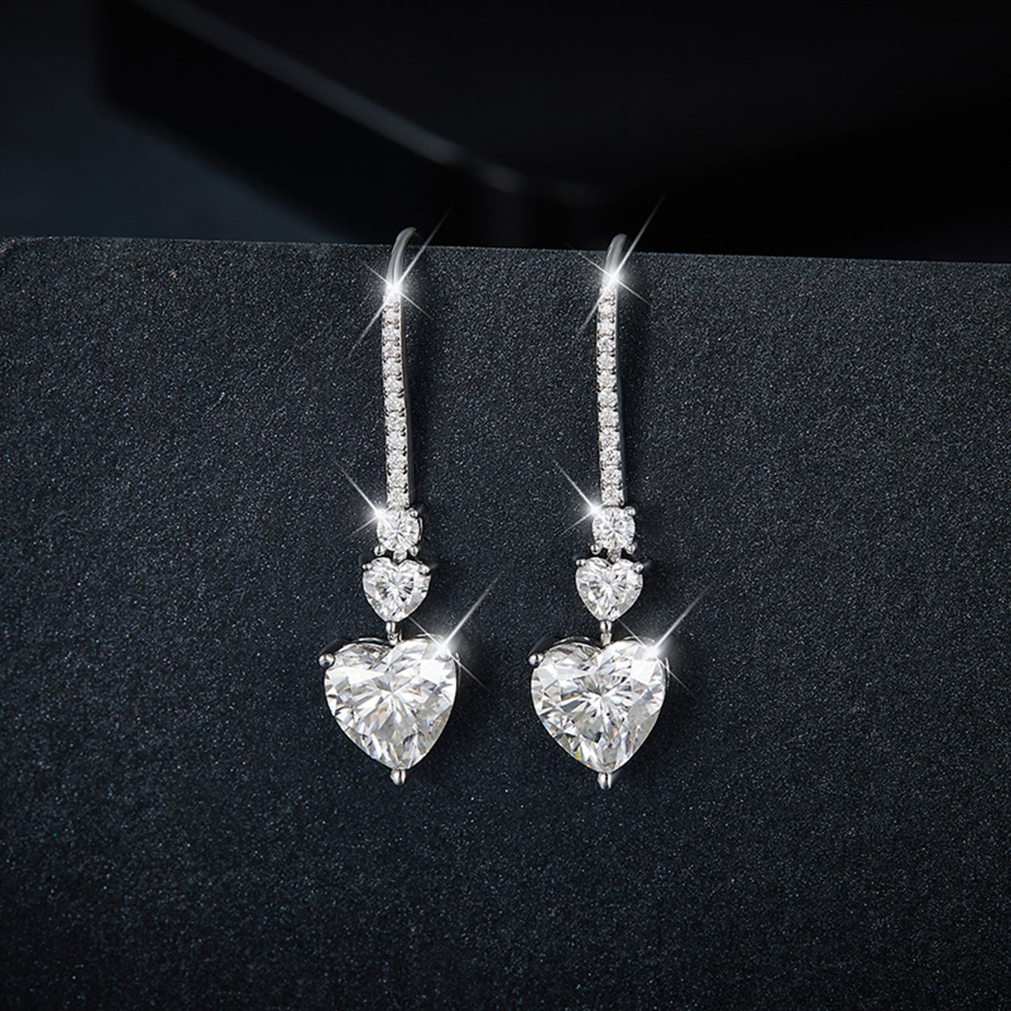5.44 Carat Sterling Silver Moissanite Heart Drop Earrings on display