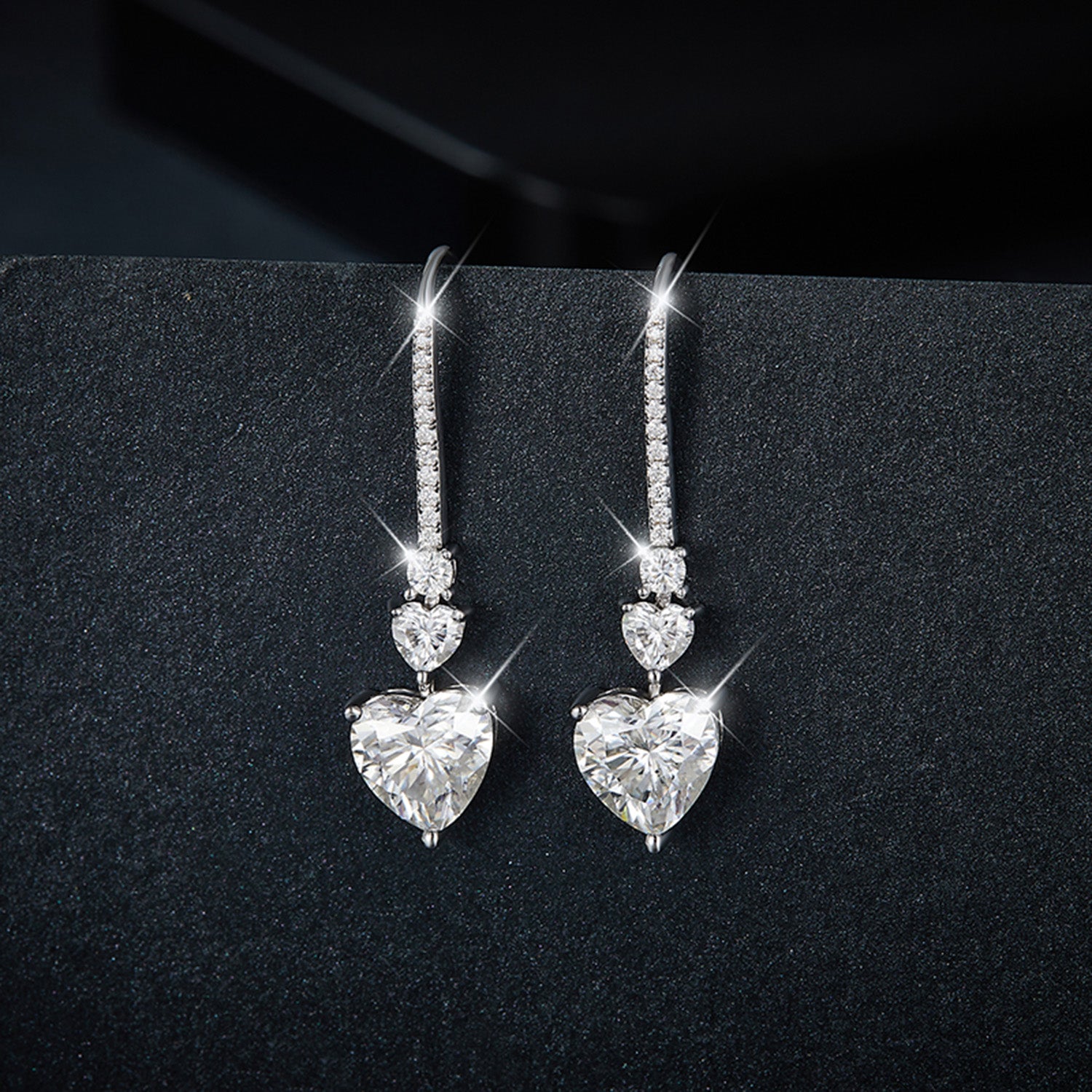 5.44 Carat Sterling Silver Moissanite Heart Drop Earrings on display
