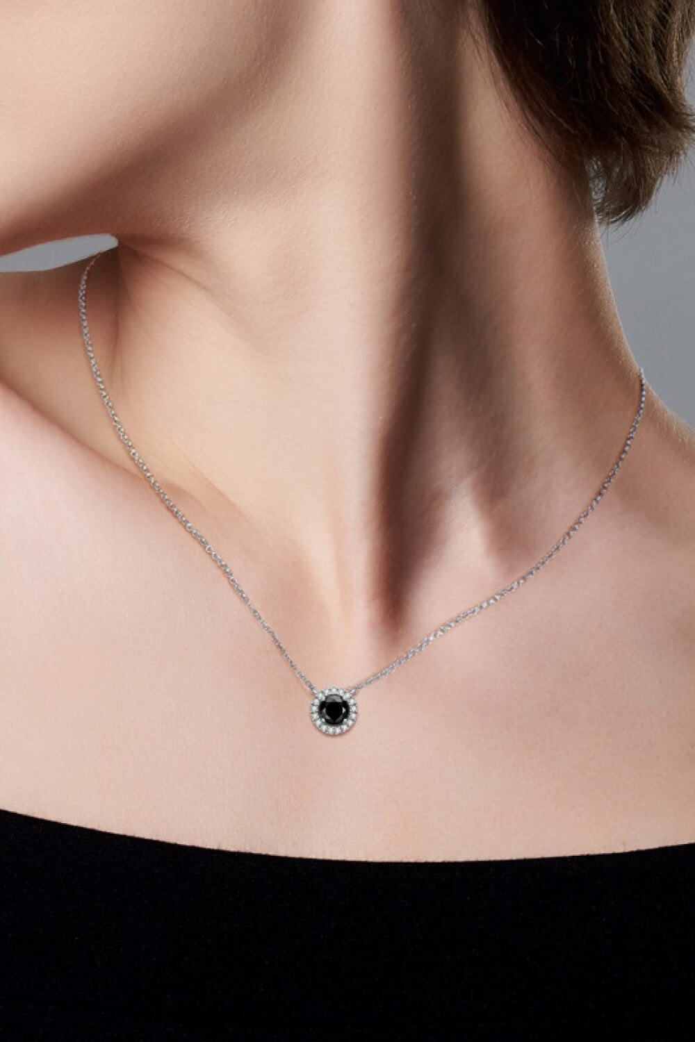 Two-Tone 1 Carat Moissanite Round Pendant Necklace around neck