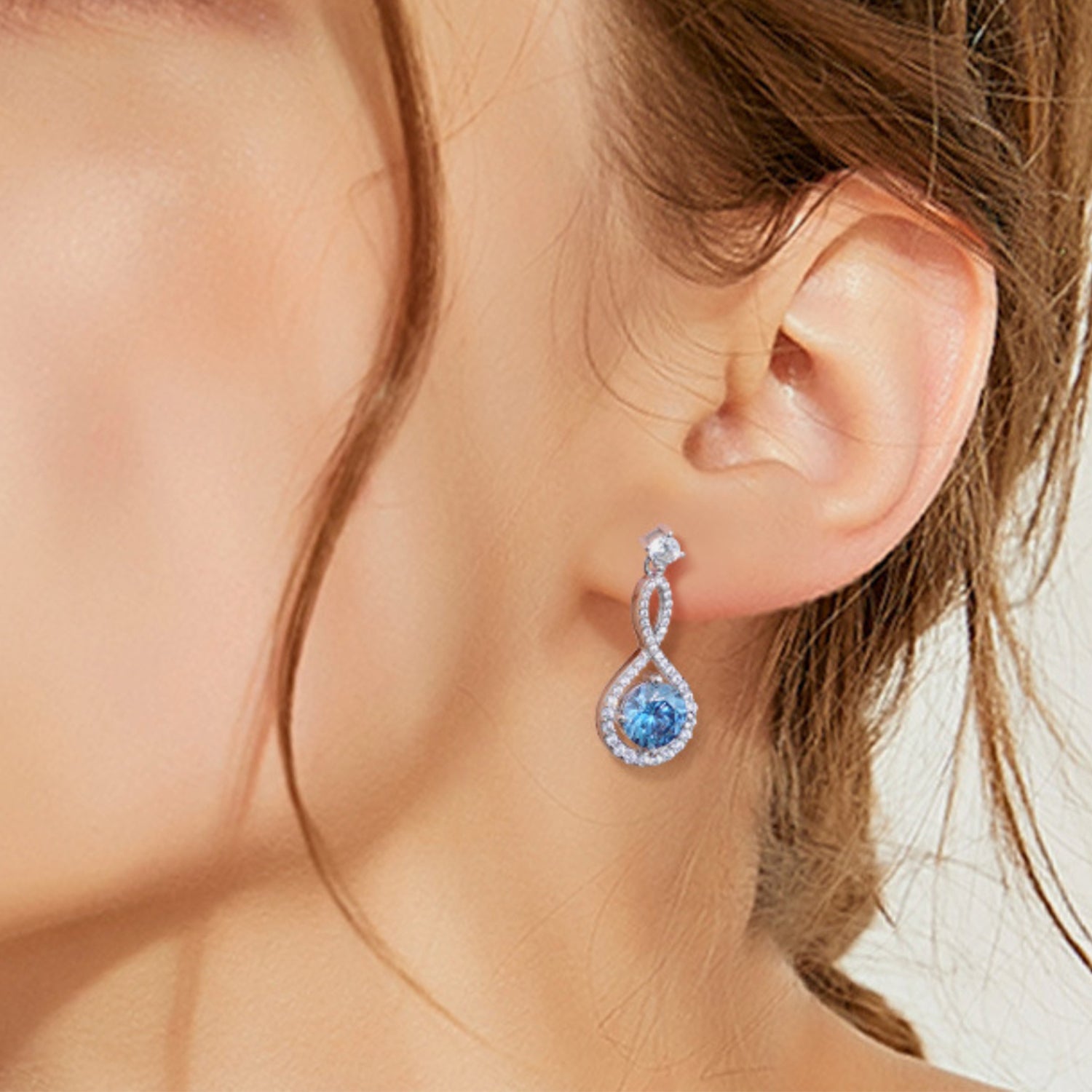 1 Carat Moissanite Sterling Silver Earrings royal blue on ears
