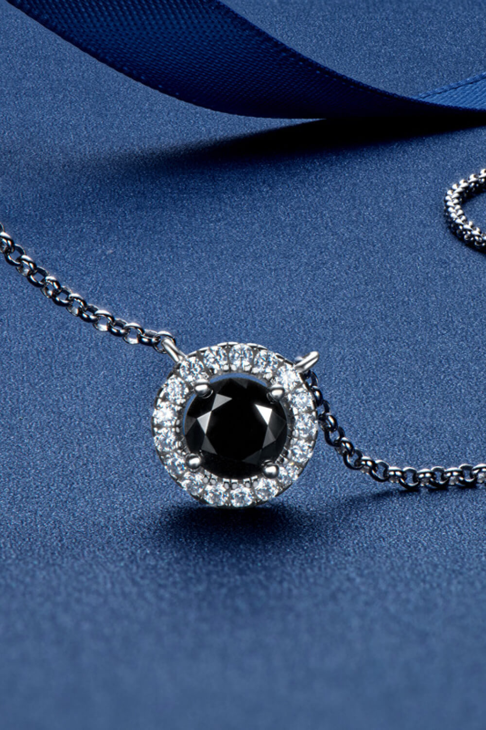 Two-Tone 1 Carat Moissanite Round Pendant Necklace on display